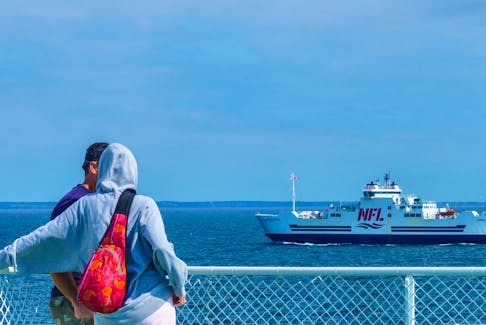 Passengers on one Northumberland Ferries vessel look across the water at a passing NFL ship travelling between Prince Edward Island and Nova Scotia. Vice president and general manager Don Cormier said all employees and travellers will need to be fully vaccinated.  
