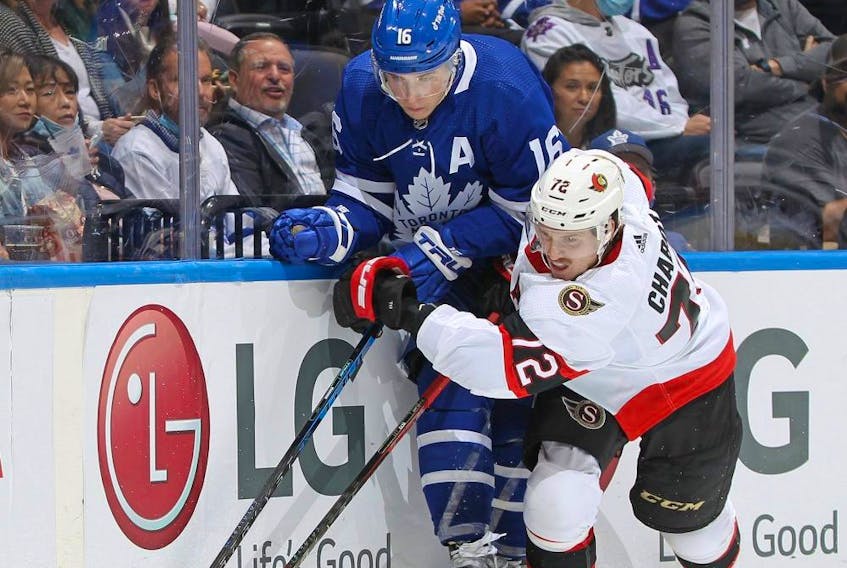 Maple Leafs winger Mitch Marner and Senators defenceman Thomas Chabot fight for the puck on Saturday night. Marner has yet to score a goal this season. GETTY IMAGES