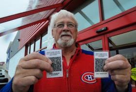 Mount Pearl resident Ray Pardy, a retired Newfoundland Power lineman, displays his and his wife Marie’s laminated QR codes Wednesday afternoon, Oct. 30. Joe Gibbons • The Telegram