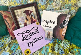 Displayed next to her YCMHS Class of 2021 graduation photo are paintings that were made by Yarmouth County teenager Hali Graves, as well as a photo of her with her parents when she was just a baby. At the age of 19, Graves died in a single-vehicle collision on Sept. 24. TINA COMEAU • TRICOUNTY VANGUARD