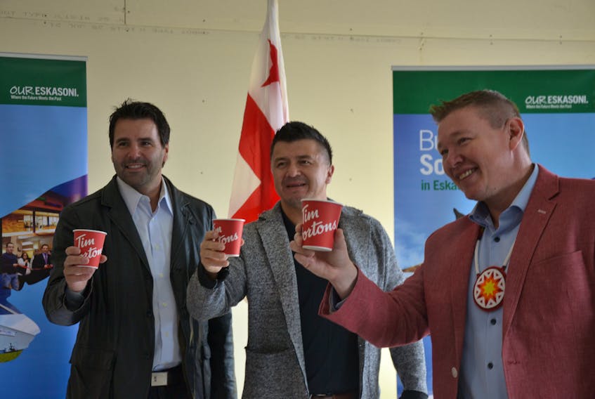 Tim Hortons franchisee Troy Wilson, left, Eskasoni Chief Leroy Denny, centre, and Sydney-Victoria MP Jaime Battiste celebrate the announcement of a new Tim Hortons location in the Mi'kmaw community, expected to open in December. ARDELLE REYNOLDS/CAPE BRETON POST