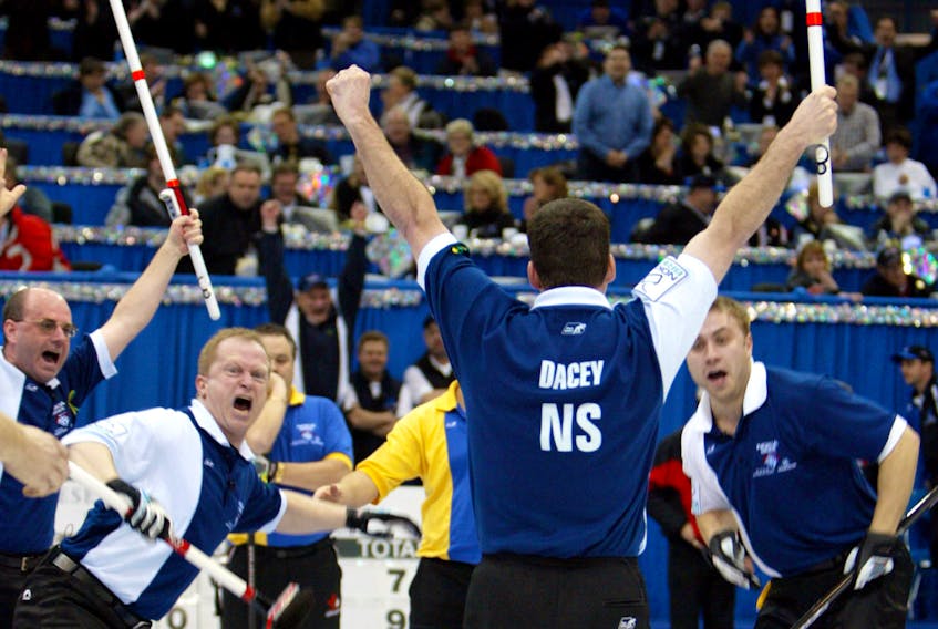 Nova Scotia skip Mark Dacey and his rink celebrate their win over Alberta in the Brier final in Saskatoon, Sask., March 14, 2004. Left to right: Third Bruce Lohnes, second Rob Harris, Dacey and lead Andrew Gibson. - Shaun Best / Reuters