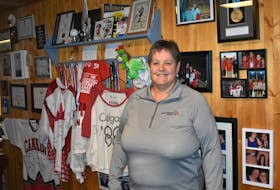 In her Stellarton home, Cathy Mason stands in front of a wall of souvenirs and special memories from the many events she has attended as a Special Olympics volunteer. 