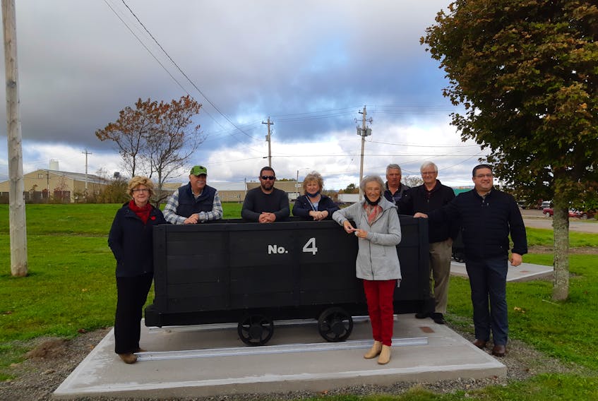 (From left) Cumberland municipal councillor Rod Gilroy, Heather Henwood, Coun. Angel McCormick, Ann Stone, Jamie Henwood, Mayor Murray Scott, Coun. Mark Joseph and Charlie Martin of Martin’s Metal Works stand beside one of two original coal cars refurbished as a memorial to Springhill’s coal mining heritage.