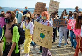 Students march along the Halifax waterfront as part of a global Climate Strike rally on Friday, Oct. 22, 2021.