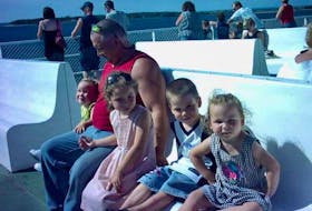 Ed Phalen with his children aboard a ferry.