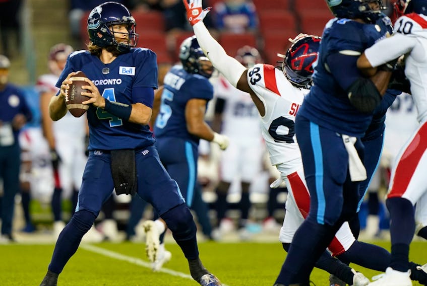 Toronto Argonauts quarterback McLeod Bethel-Thompson (4) looks to pass as he is pressured by Montreal Alouettes defensive lineman Antonio Simmons (93) at BMO Field in Toronto on Sept. 24, 2021.