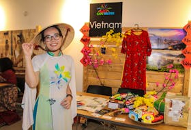 Second-year Cape Breton University student Ellyna Tran, who is from Vietnam, shares Vietnamese culture at the Hello Cape Breton: A World Gathering on an Island annual multicultural festival at the Convent in Sydney on Saturday. She is wearing an ao dai, a traditional Vietnamese garment. JESSICA SMITH/CAPE BRETON POST
