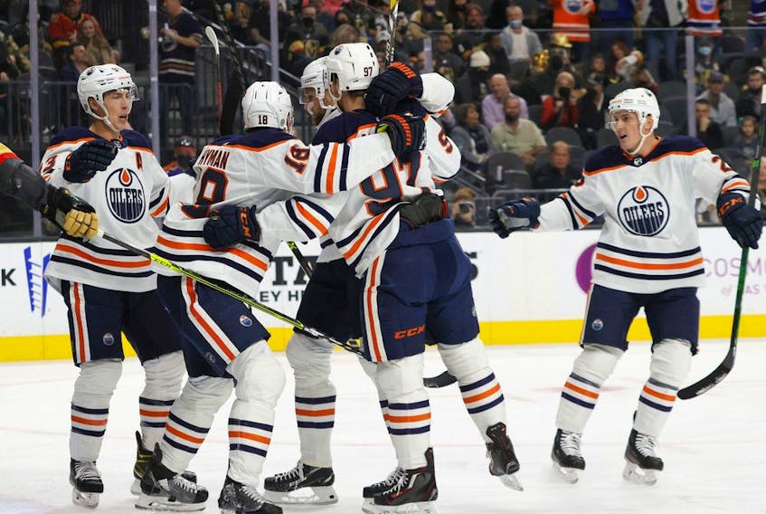 The Edmonton Oilers celebrate a first-period power-play goal by Zach Hyman (18) against the Vegas Golden Knights at T-Mobile Arena on Oct. 22, 2021, in Las Vegas.