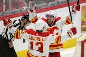  Elias Lindholm celebrates with Johnny Gaudreau after scoring in overtime against the Washington Capitals on Saturday.