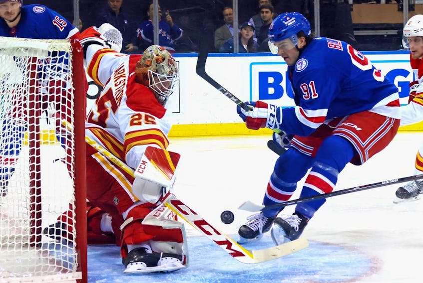 Calgary Flames goaltender Jacob Markstrom makes a save on the New York Rangers’ Sammy Blais at Madison Square Garden in New York on Monday, Oct. 25, 2021.