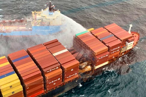 A tugboat pours water on the container ship Zim Kingston after it caught fire off the coast of British Columbia on Oct. 25. Canadian Coast Guard/Handout via REUTERS
