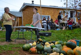A pile of freshly washed squash can be seen while the community gardeners take a break from the harvest to share a potluck lunch. ARDELLE REYNOLDS • CAPE BRETON POST