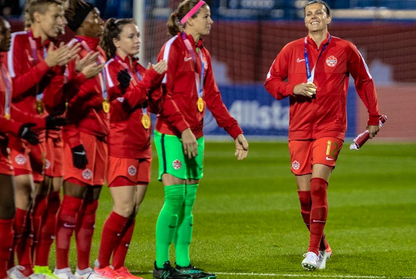  Team Canada’s Christine Sinclair, right, is introduced to the crowd before the start of the friendly match against Team New Zealand at Saputo Stadium on Tuesday.