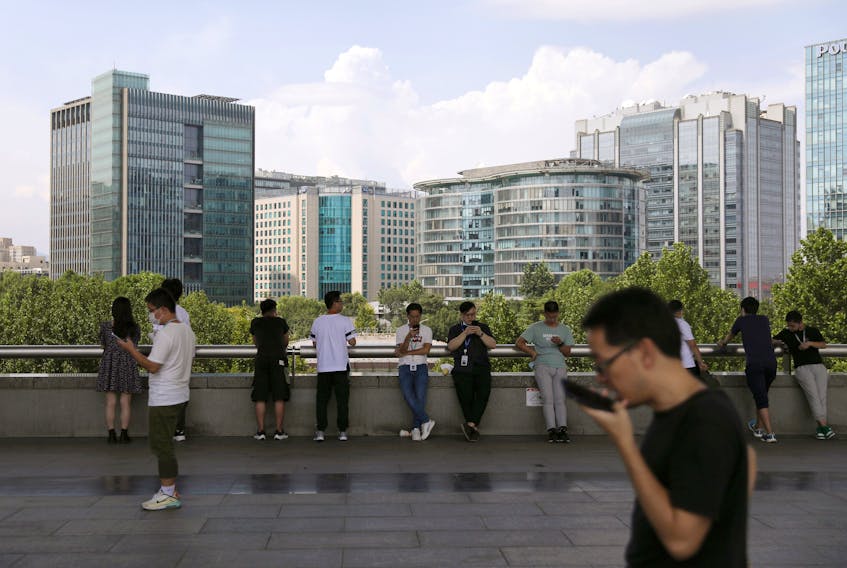 People are seen at Beijing's tech hub Zhongguancun, China on Aug. 23. There is evidence indicating that gay people in China “suffer significant levels of discrimination and intra-familial violence,” Justice John Norris said in his ruling. REUTERS file photo/Tingshu Wang