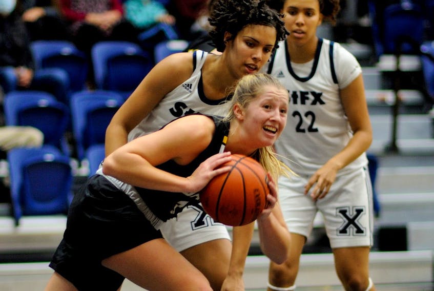 Hannah Chadwick of Dalhousie is guarded by Tyra Atherley of St. Francis Xavier as her sister Kira Atherley looks on during an AUS women's basketball pre-season game Oct. 9 in Antigonish. - BRYAN KENNEDY / ST. F.X. ATHLETICS