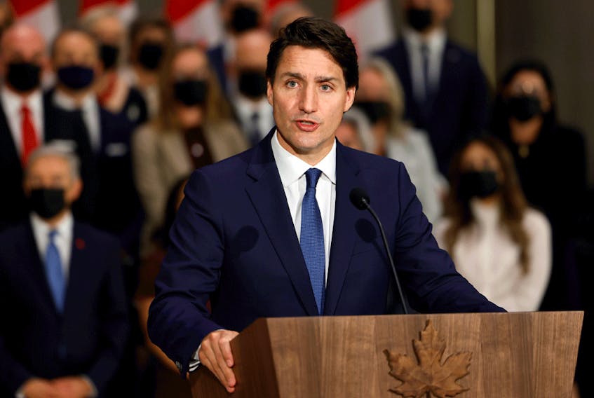 Prime Minister Justin Trudeau speaks in front of members of his new cabinet on October 26, 2021.