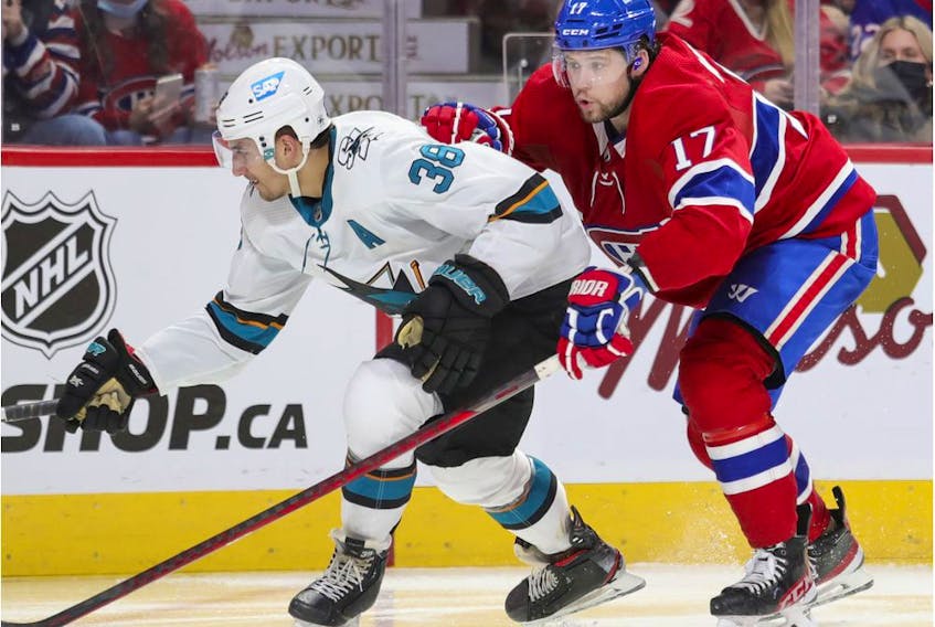 Montreal Canadiens' Josh Anderson leans on San Jose Sharks' Mario Ferraro during third period in Montreal on Oct. 19, 2021. 