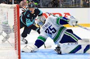  Thatcher Demko of the Vancouver Canucks makes the save against the Seattle Kraken during the Kraken’s inaugural home-opener Oct. 23 at Climate Pledge Arena.