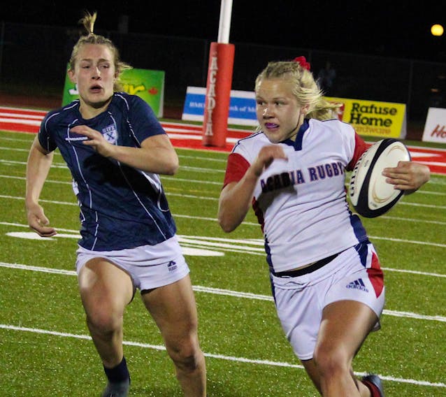 Acadia centre Emilie Merilainen breaks on the outside against St. Francis Xavier during an AUS women's rugby game Oct. 15 in Wolfville. The Axewomen will host the X-Women again in the conference championship on Sunday afternoon at Raymond Field. - JASON MALLOY / SALTWIRE NETWORK