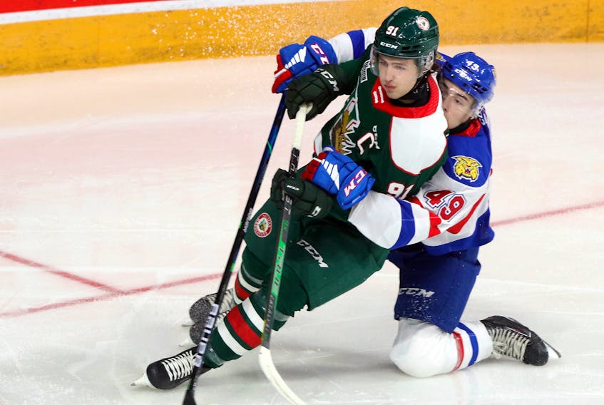 Halifax Mooseheads' Elliot Desnoyers gets a hug from Moncton's' Maxim Barbashev as he hovers around the Wildcats' net early in the first period.