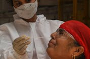  A medical staff takes a nasal swab for a Rapid Antigen Testing (RAT) test amidst rising COVID-19 coronavirus cases, in Mumbai on April 19, 2021.