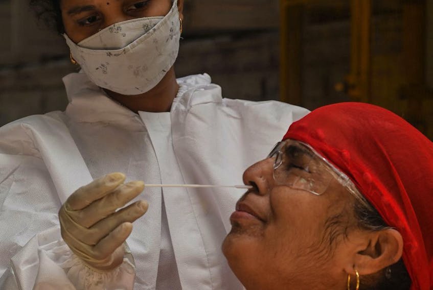  A medical staff takes a nasal swab for a Rapid Antigen Testing (RAT) test amidst rising COVID-19 coronavirus cases, in Mumbai on April 19, 2021.