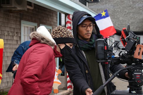 Director Kelly Caseley, left, and camera operator Oakar Myint check the framing of the next shot on the set of Aww Shucks in October 2020.