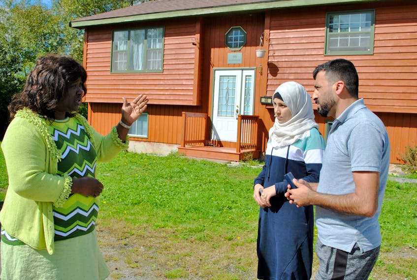 YREACH immigration settlement staff Dolores Atwood (left) talks with Alaa and Amani Almanjar outside their Shelburne home. The Almanjars are an example of a refugee family that have successfully made a small rural community home, says Atwood. Kathy Johnson
