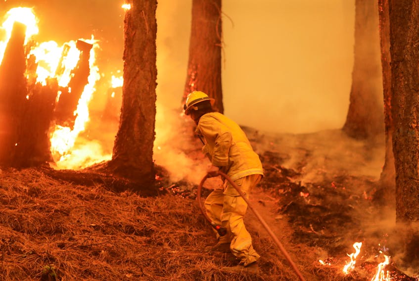 A firefighter works the Dixie Fire near Taylorsville, Cali., U.S., Aug. 10. REUTERS 