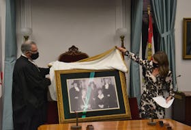 Speaker Colin LaVie and Minister responsible for the Status of Women Natalie Jameson unveil a portrait of the Famous Five, which has been permanently installed in P.E.I.'s Legislative Chamber. 