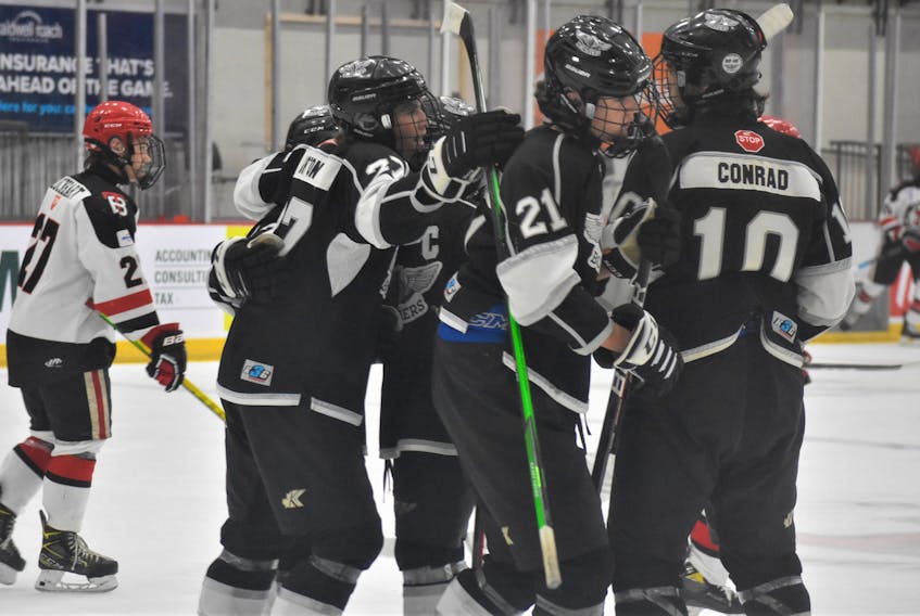 The Bombers celebrate Logan Roop’s (#21) second-period, power-play goal versus the Bearcats.  
