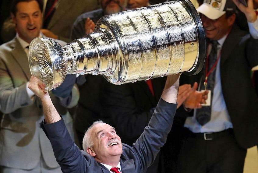 Head coach Joel Quenneville of the Chicago Blackhawks celebrates by hoisting the Stanley Cup after defeating the Tampa Bay Lightning 2-0 in Game 6 to win the 2015 Stanley Cup final at the United Center on June 15, 2015, in Chicago.