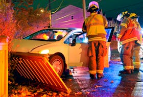 A two-vehicle crash sent two people to hospital, damaged a parked car and a fence in St. John's Friday night.