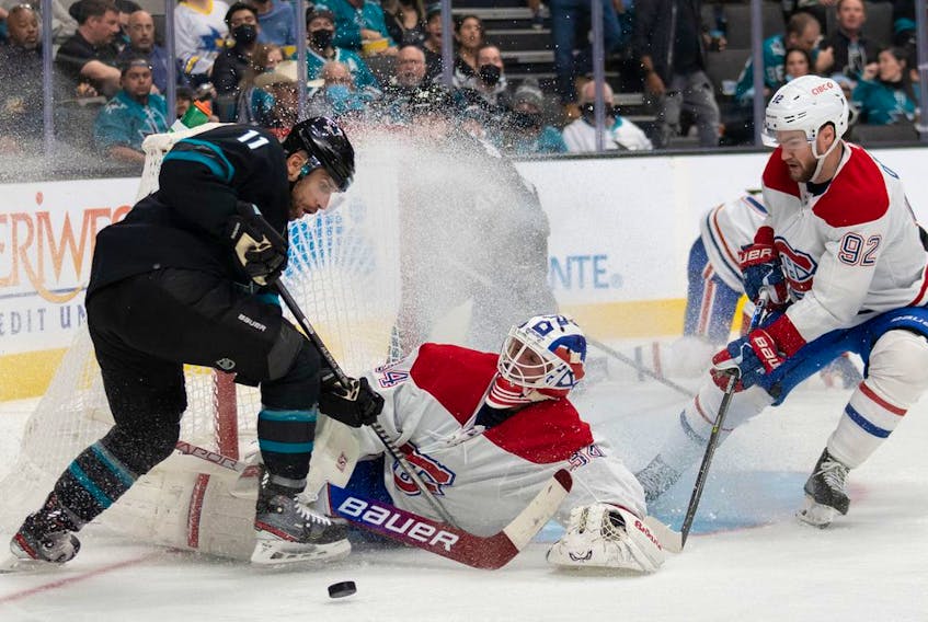 Montreal Canadiens goaltender Jake Allen (34) falls in front of San Jose Sharks centre Andrew Cogliano (11) and Habs' left wing Jonathan Drouin in San Jose. 