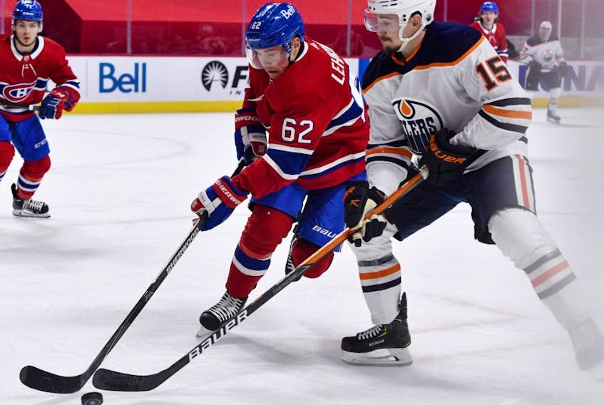  Montreal Canadiens forward Artturi Lehkonen (62) and Edmonton Oilers forward Josh Archibald (15) battle for the puck during the first period at the Bell Centre. 