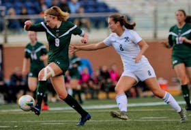 Emma Clark of the Cape Breton Capers carries the ball as she's chased by Amanda Smith of the St. Francis Xavier X-Women during Atlantic University Sport action at at StFX Stadium in Antigonish, Friday. Cape Breton won the game 1-0. PHOTO CONTRIBUTED/BRYAN KENNEDY