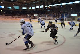 Charlottetown Islanders centre and captain Brett Budgell forechecks on Peter Reynolds of the Saint John Sea Dogs during second-period action on Oct. 2. The Islanders won the Quebec Major Junior Hockey League game at Eastlink Centre in Charlottetown 5-2.