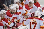The Calgary Flames’ Milan Lucic celebrates with teammates, including Mark Stone (26), after scoring against the Pittsburgh Penguins at PPG Paints Arena in Pittsburgh on Thursday, Oct. 28, 2021.