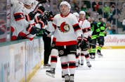 Josh Norris of the Senators celebrates with teammates after scoring a goal against the Stars in the first period of Friday's game in Dallas.