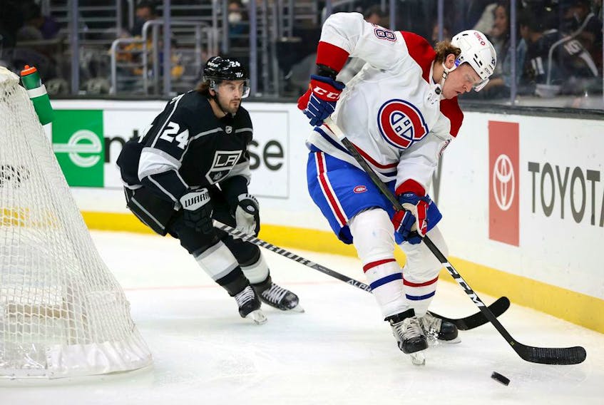 Canadiens' Christian Dvorak skates the puck against former Hab Phillip Danault (24) of the Los Angeles Kings in the first period at Staples Center on Saturday, Oct. 30, 2021, in Los Angeles.