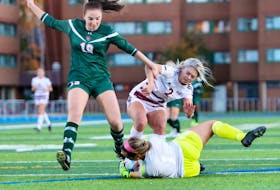 Abby MacNeil of the Cape Breton Capers, left, tries to chip the ball over Saint Mary's Huskies goalkeeper Grace Morrison during Atlantic University Sport action at Huskies Stadium on Friday. Cape Breton won the game 4-1. PHOTO CONTRIBUTED  • SAINT MARY'S HUSKIES