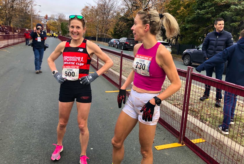 Kate Bazeley (right), who won her fifth Tely 10 female championship Sunday, charts with runner-up Anne Johnston after the two posted the third and fourth times by a woman in the history of the race and made history by both finishing in the overall top five. — Joe Gibbons/The Telegram