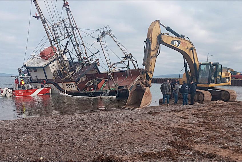An excavator at the scene where the Northern Tip fishing vessel was aground in Iona on Saturday, as the recovery work got underway. Contributed/Jim MacNeil