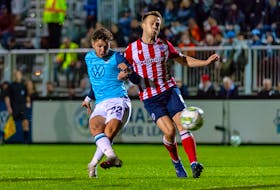 HFX Wanderers star Joao Morelli battles for the ball with Atletico Ottawa's Ben McKendry during last Wednesday's Canadian Premier League match at the Wanderers Grounds. - CANADIAN PREMIER LEAGUE