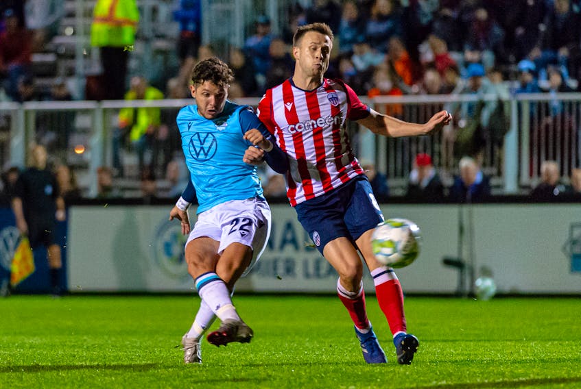 HFX Wanderers star Joao Morelli battles for the ball with Atletico Ottawa's Ben McKendry during last Wednesday's Canadian Premier League match at the Wanderers Grounds. - CANADIAN PREMIER LEAGUE