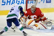  The Vancouver Canucks’ Brad Hunt has a scoring chance on Calgary Flames goaltender Jacob Markstrom in preseason action at the Saddledome on Friday, Oct. 1, 2021.