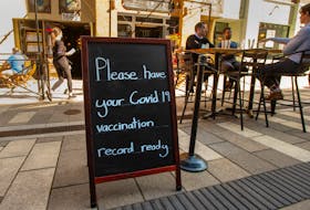 A sign outside the Economy Shoe Shop asks people to have their proof of vaccination ready on Thursday, Oct. 7, 2021.