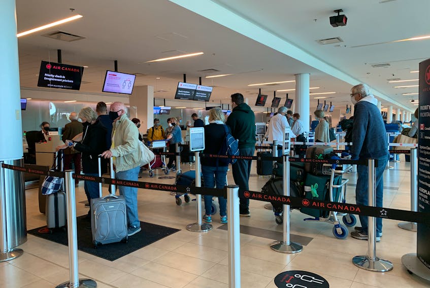 Oct. 8, 2021 - Travellers line up to check in for their flights at the Halifax Stanfield International Airport on Friday.