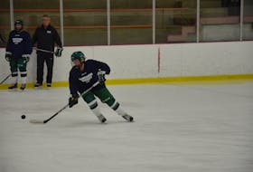 Ally Clements of the UPEI Panthers looks to control the puck during a practice earlier this week. Team manager Don MacFadyen and Stephanie Leger look on. The Panthers host the Mount Allison Mounties in their 2021-22 Atlantic University Sport women’s hockey home opener at MacLauchlan Arena on Oct. 9 at 7 p.m.